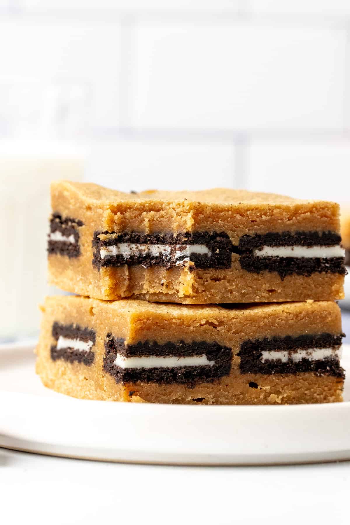 Two peanut butter Oreo blondies, one on top of each other on a plate.