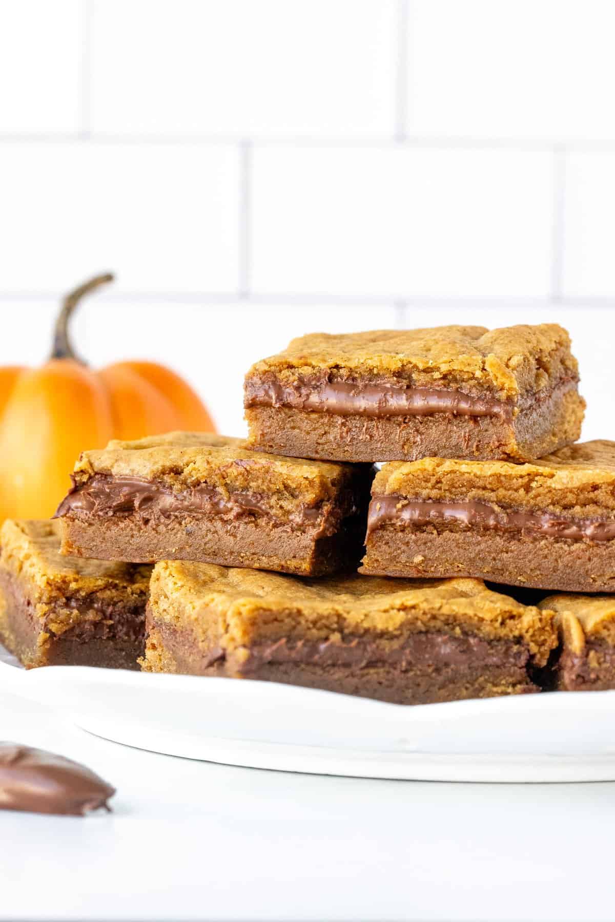 Plate of pumpkin Nutella cookie bars, stacked.
