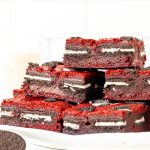 Plate of Oreo red velvet brownies, stacked on top of each other.