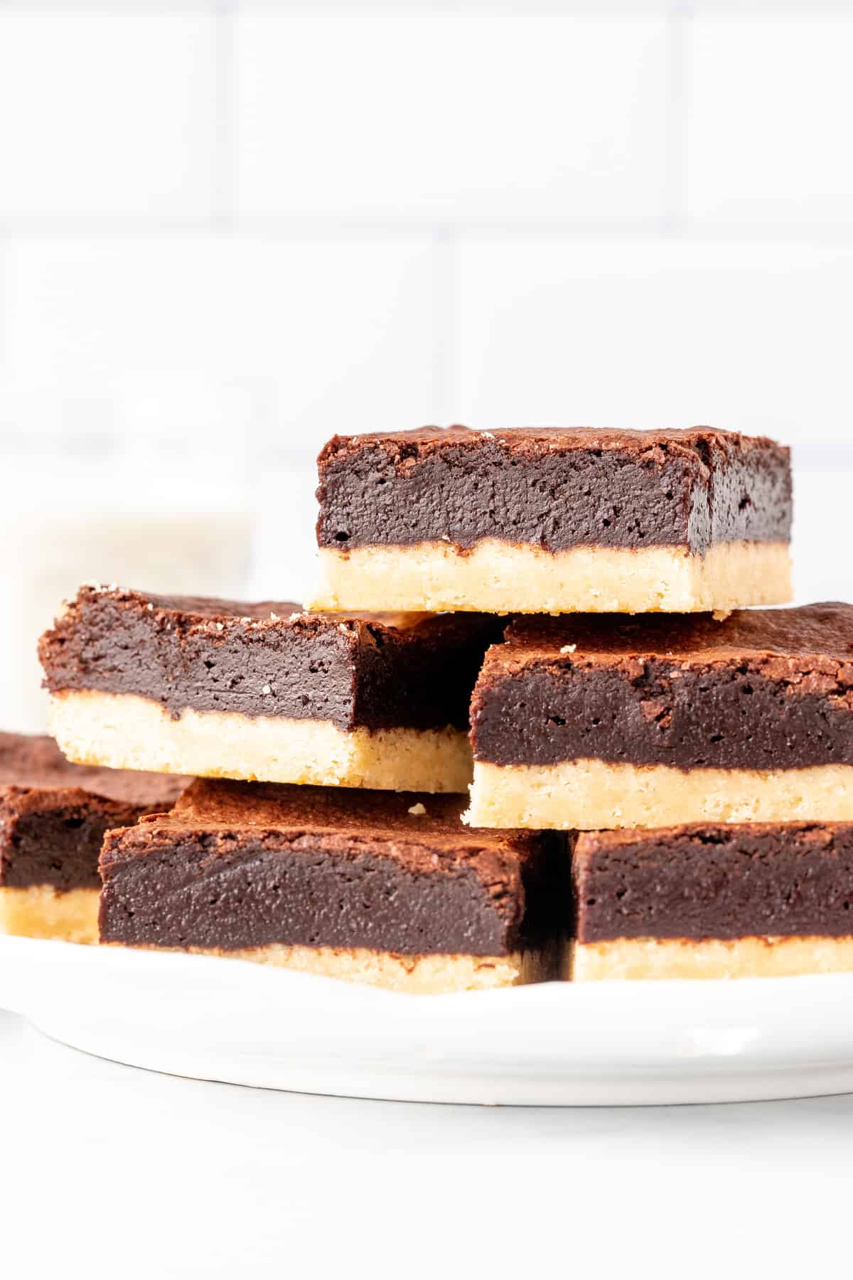 Plate of shortbread brownies, stacked on top of each other. 