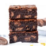 Stack of three chocolate orange brownies, one on top of each other