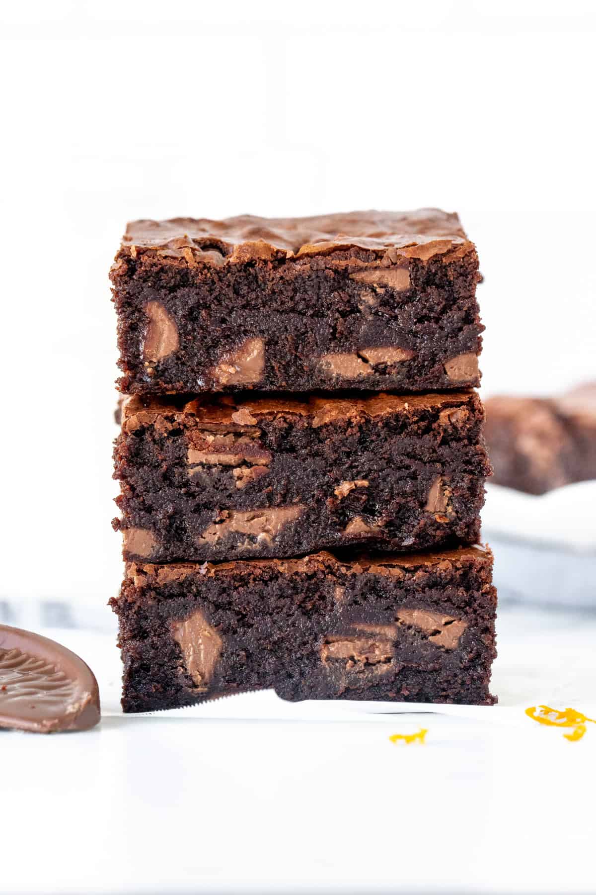Stack of three chocolate orange brownies, one on top of each other