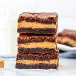 Stack of 3 peanut butter stuffed brownies with glass of milk