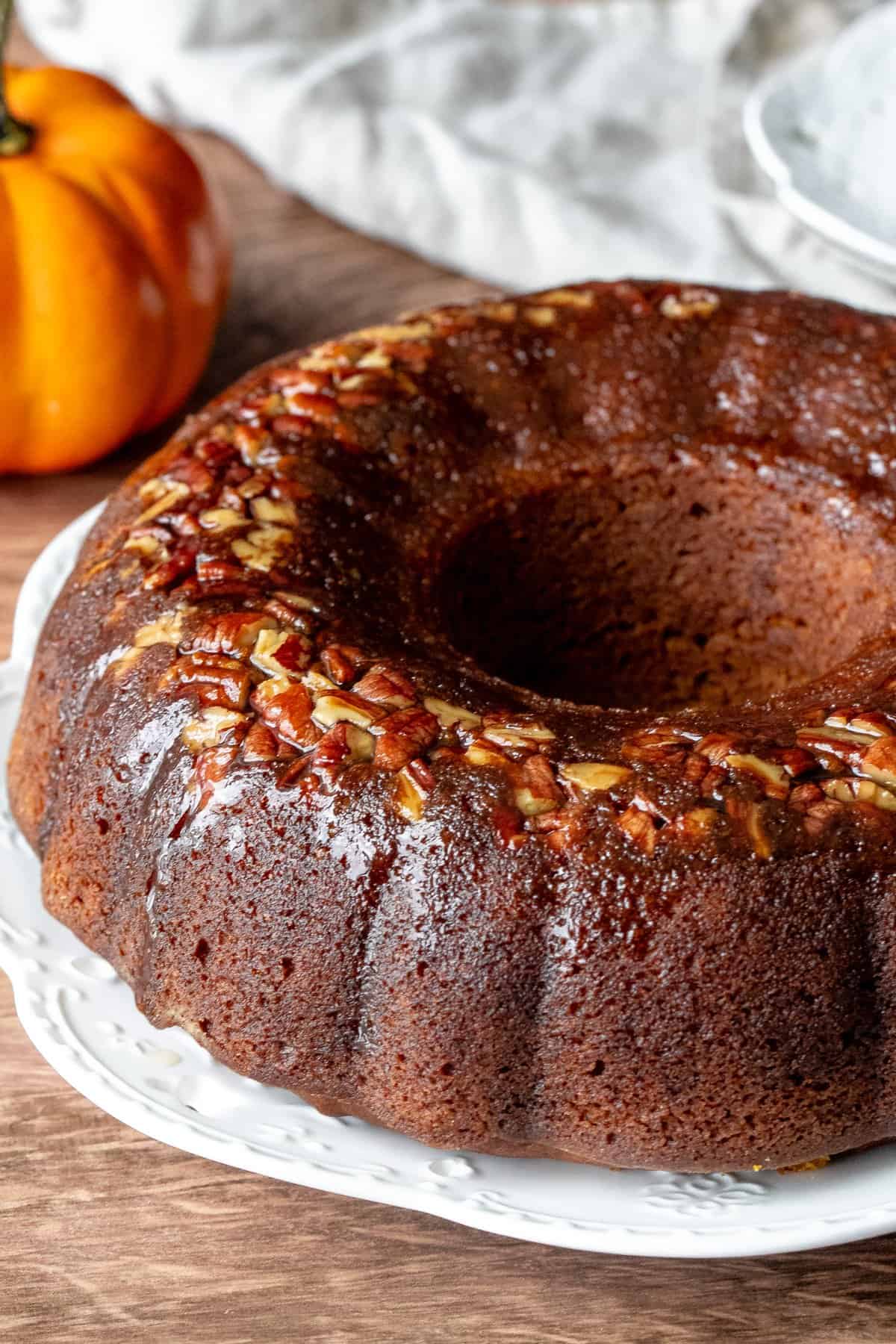 Pumpkin rum cake made in a bundt pan on a white place