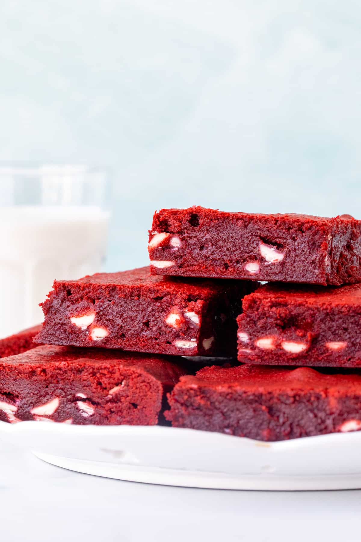 Plate of red velvet brownies filled with white chocolate chips