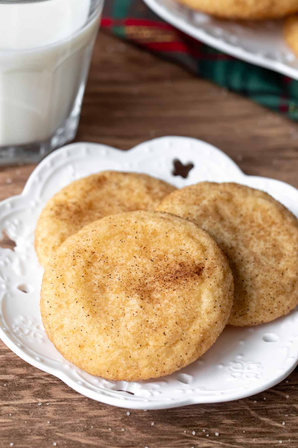 Small plate of three snickerdoodles with glass of milk