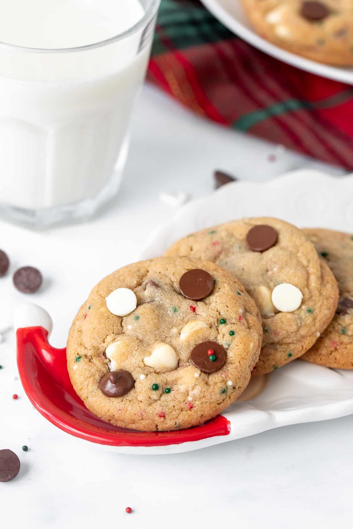 Small Santa plate of chocolate chip cookies with sprinkles and a glass of milk