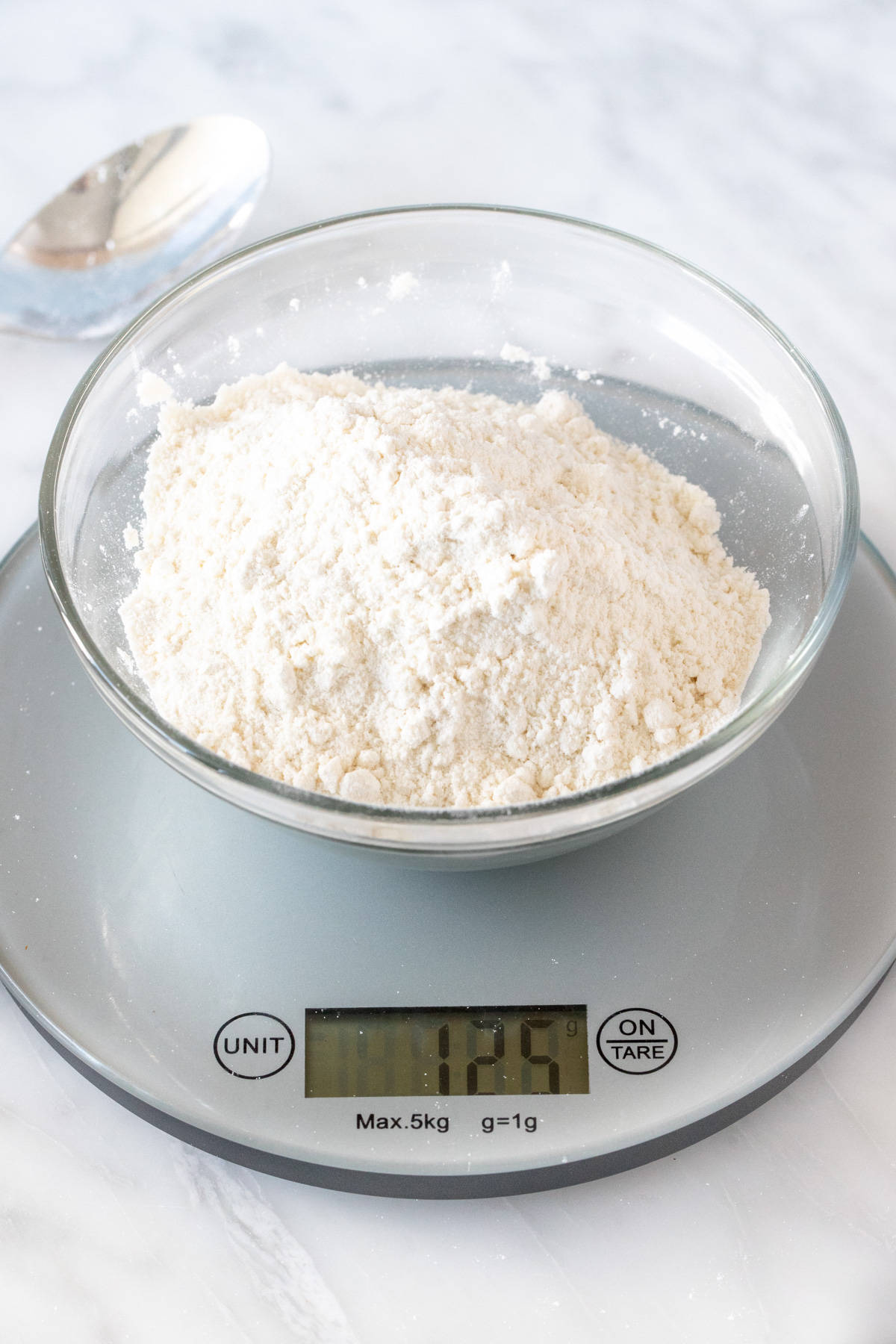 Bowl of flour on kitchen scale with 125 grams
