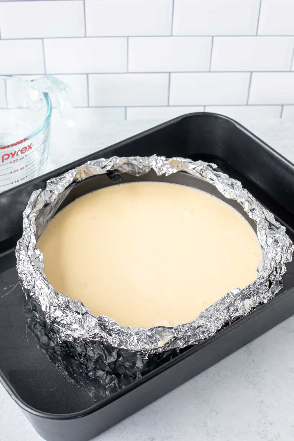 Unbaked cheesecake in a water bath