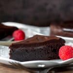 Slice of flourless chocolate cake with chocolate ganache