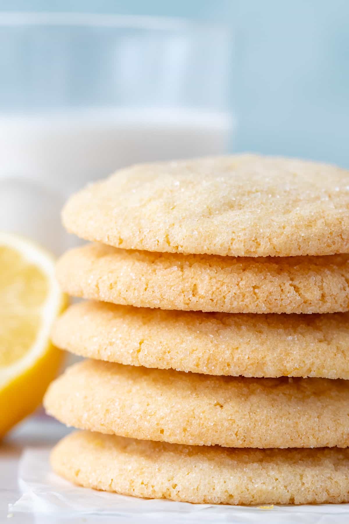 Stack of lemon cookies with glass of milk