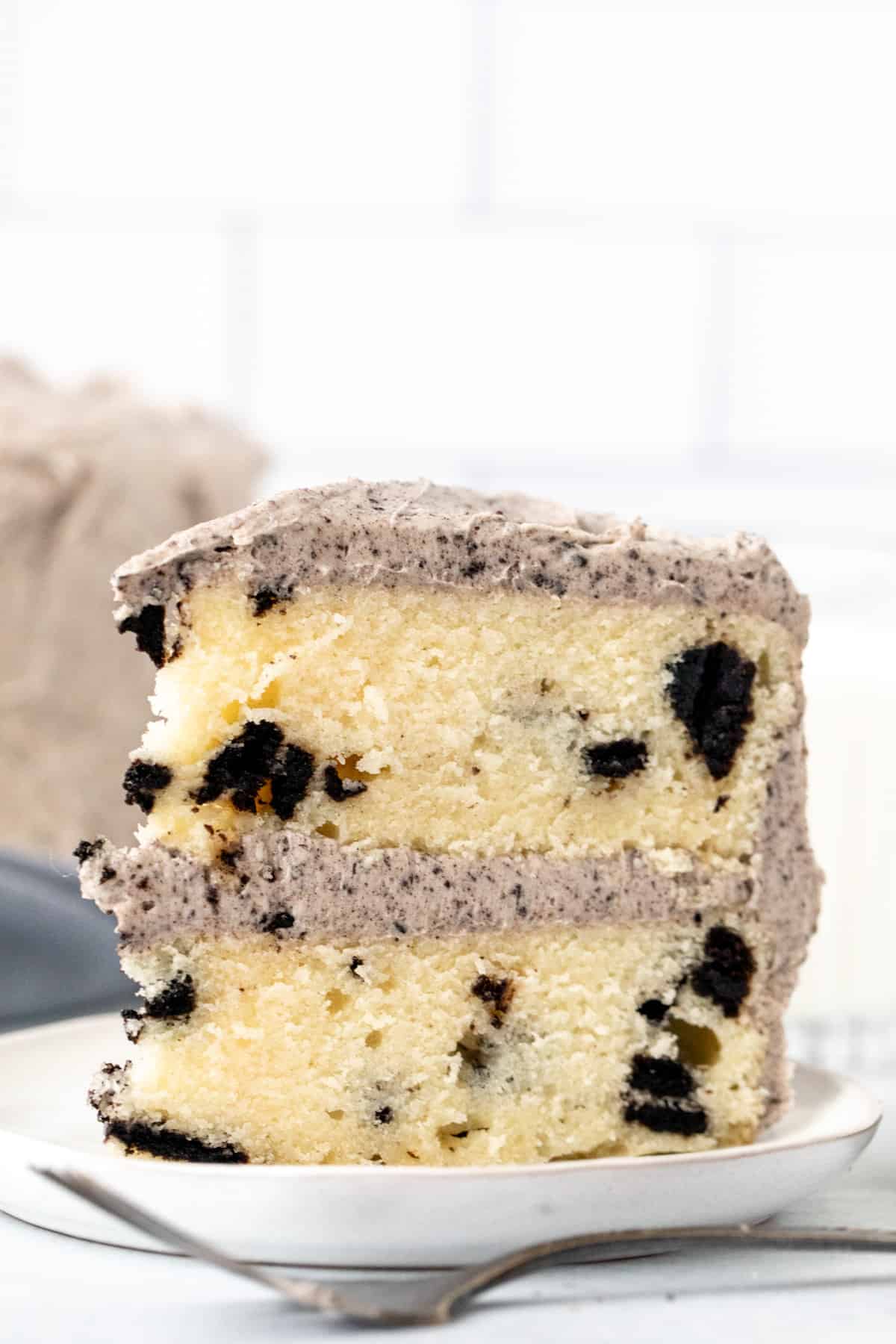 Slice of Oreo cake with cookies and cream frosting