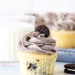 Oreo cupcake with Oreo frosting with a glass of milk