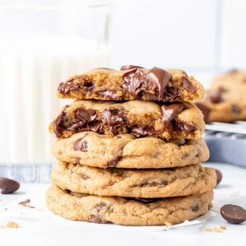 Stack of cream cheese chocolate chip cookies with top cookie broken in half.