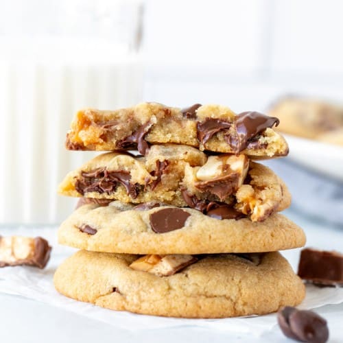 Stack of Snickers cookies, with top cookie broken in half