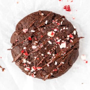 Chocolate peppermint cookie with drizzle of chocolate and crushed candy canes on top