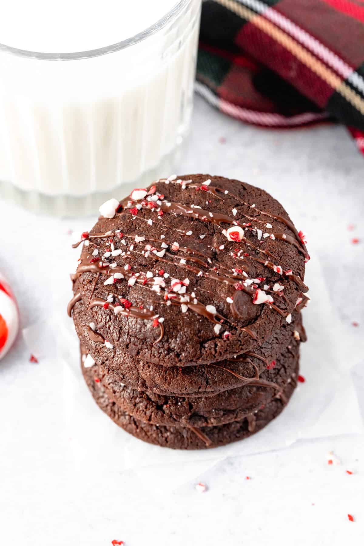Stack of double chocolate peppermint cookies with glass of milk