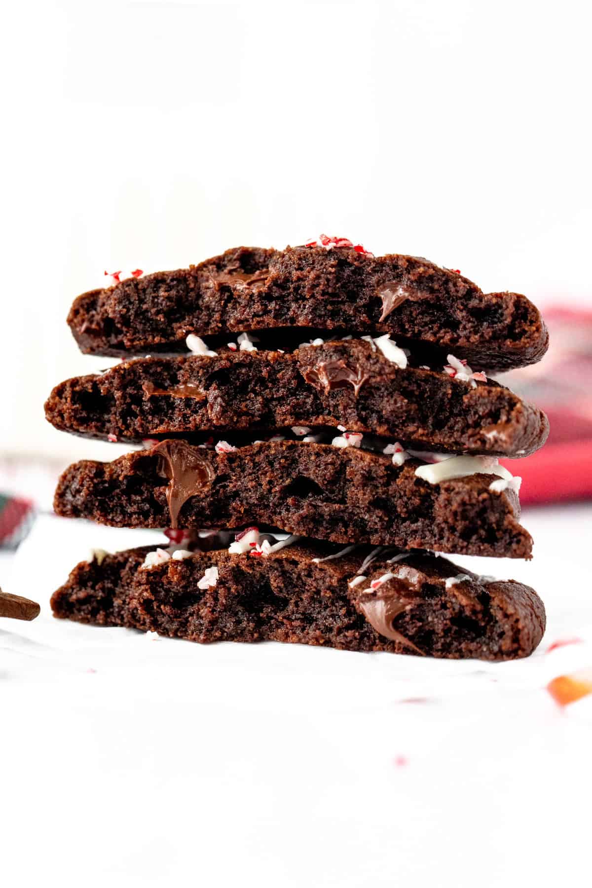 Peppermint mocha chocolate cookies broken in half, and stacked on top of another