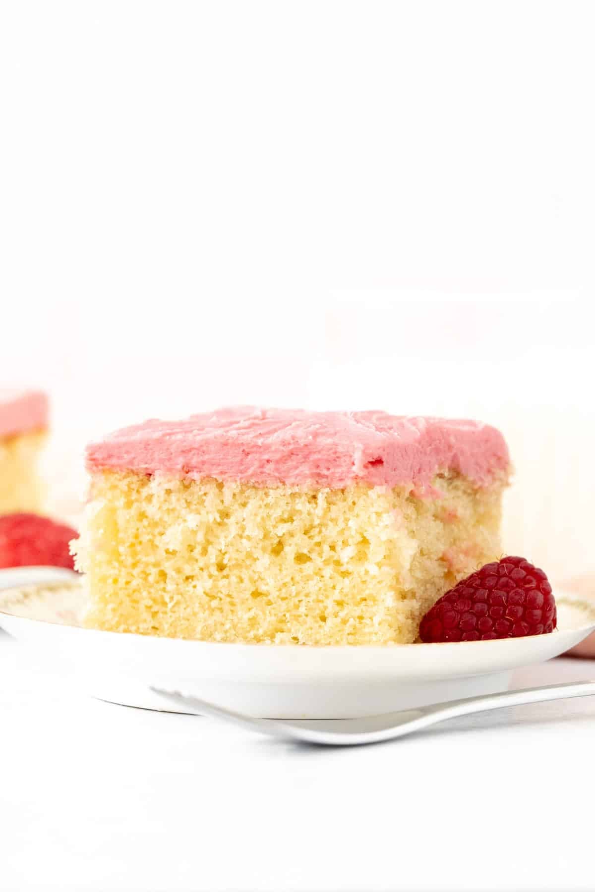 Slice of almond cake with raspberry frosting