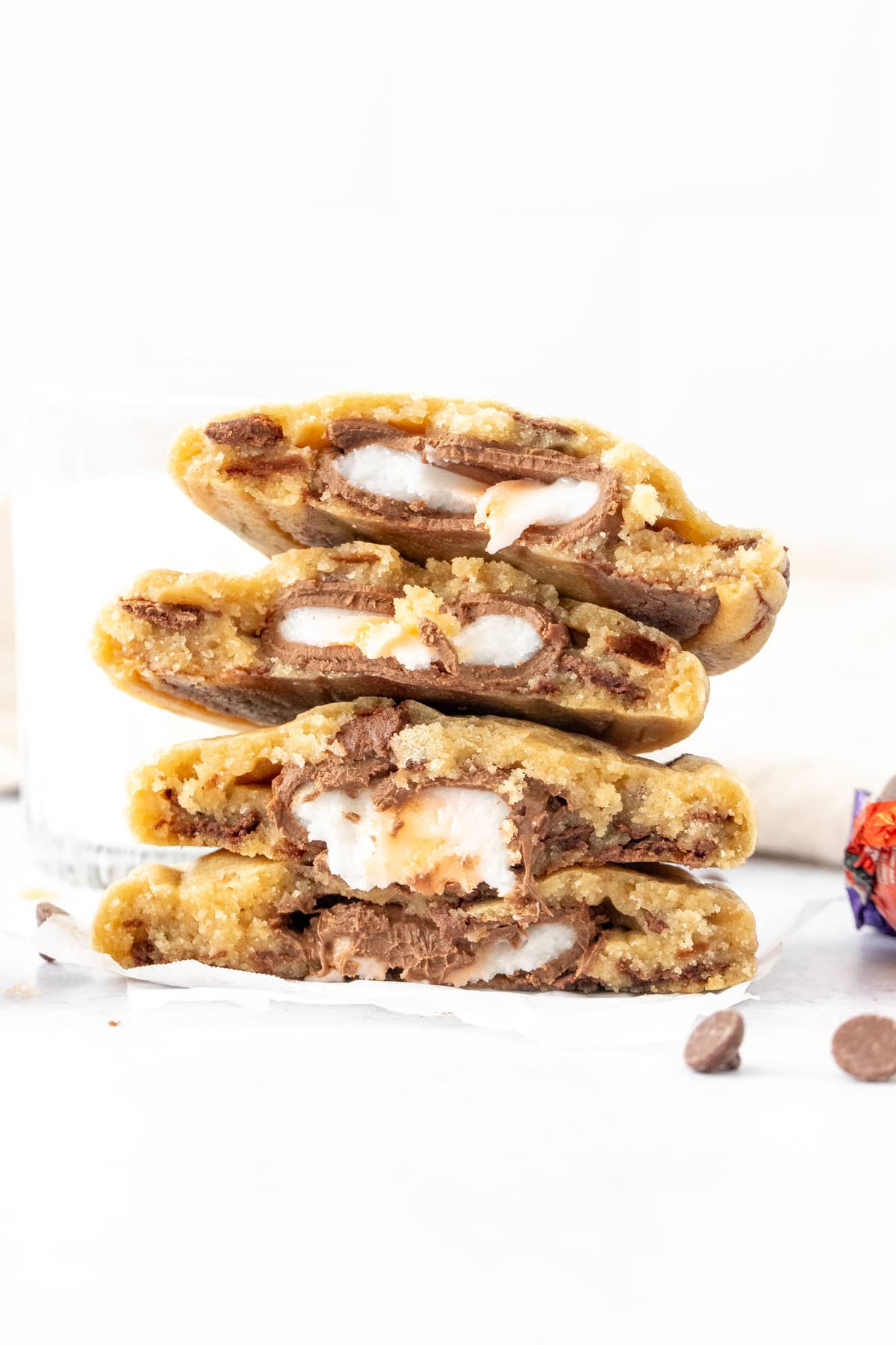 Stack of Cadbury Cream Egg stuffed chocolate chip cookies, broken in half