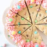 Easter cookie cake decorated with pink frosting, cut into slices