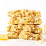 lemon white chocolate chip cookies, broken in half and stacked on top of one another