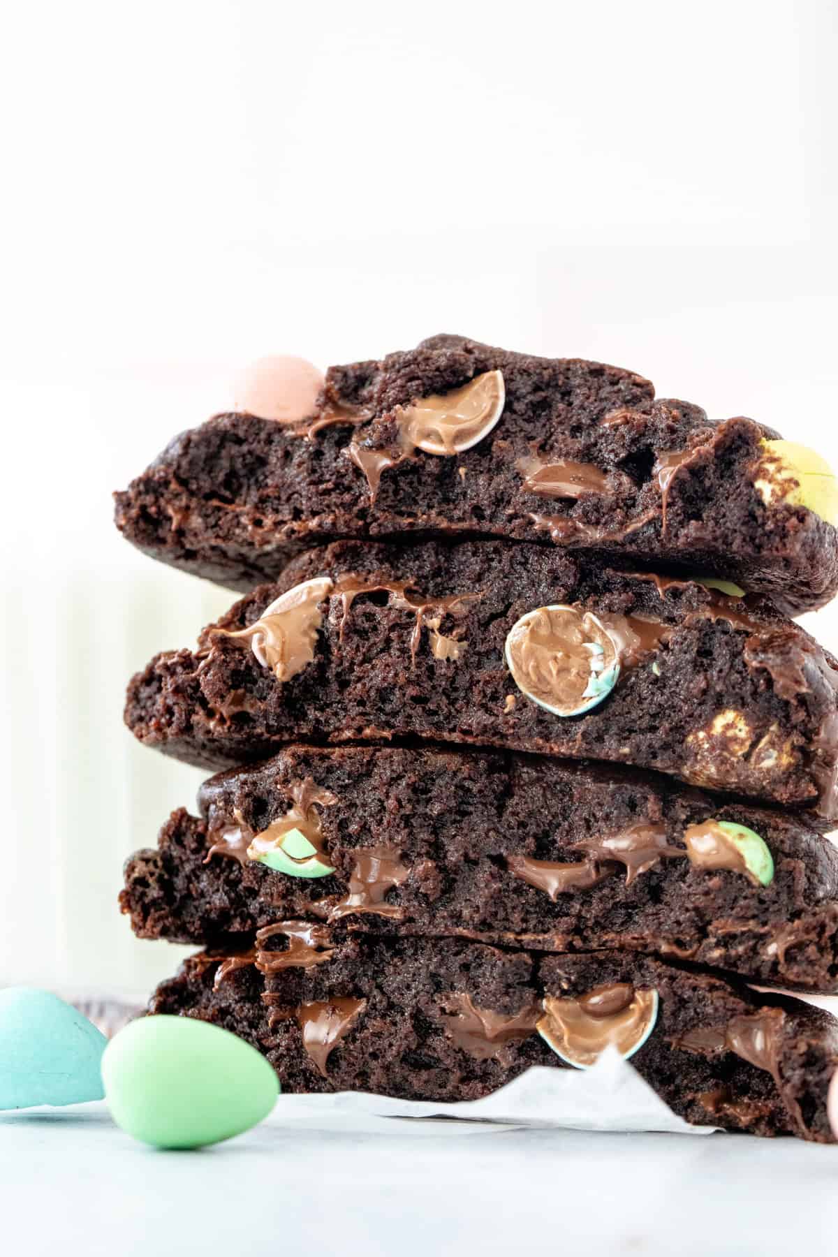 Chocolate cookies with Easter Candies, broken in half and stacked on top of one another