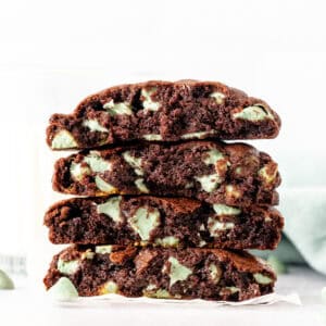 Mint chip chocolate cookies broken in half, and stacked on top of one another
