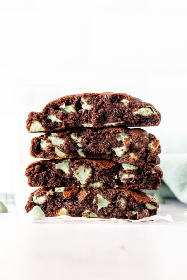 Mint chip chocolate cookies broken in half, and stacked on top of one another