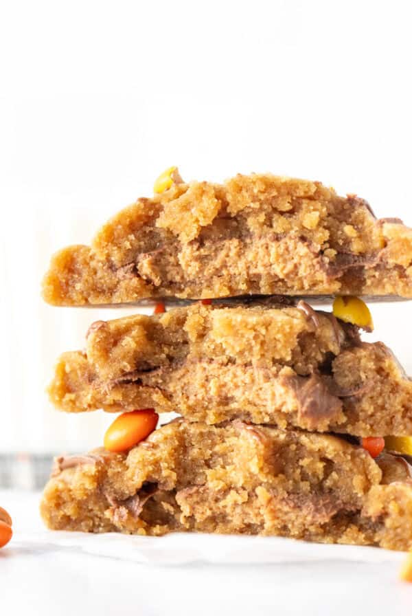 Peanut butter cookies stuffed with a peanut butter cup in the middle, broken in half and stacked on top of one another