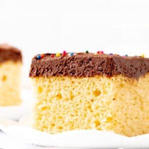 Slice of yellow sheet cake with chocolate frosting