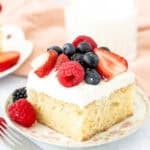 Slice of vanilla sheet cake with whipped cream and berries