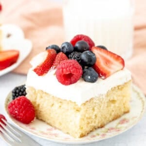 Slice of vanilla sheet cake with whipped cream and berries