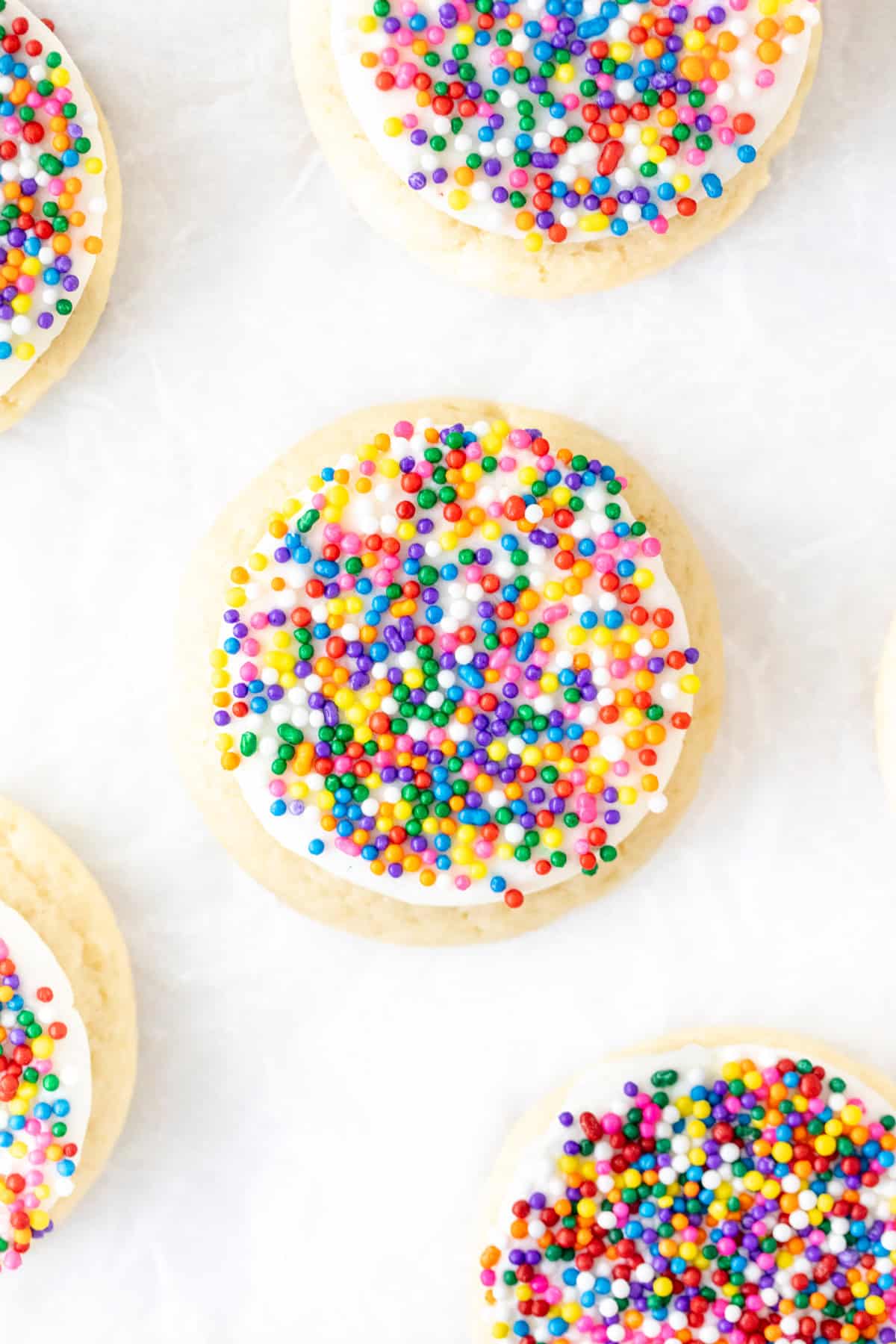 Sugar cookies with vanilla frosting and nonpareil sprinkles