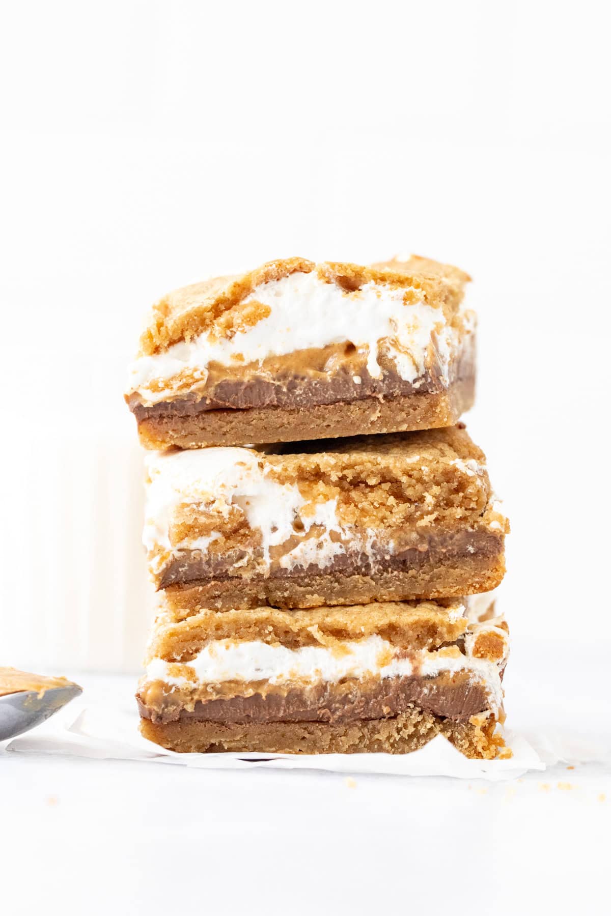 gooey peanut butter cookie s'mores bars, stacked one on top of another