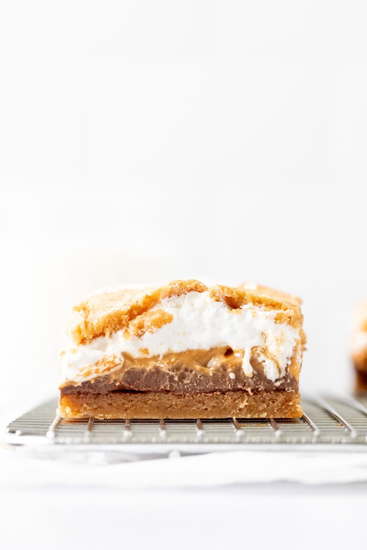 Peanut butter s'mores cookie dough bar on a cooling rack