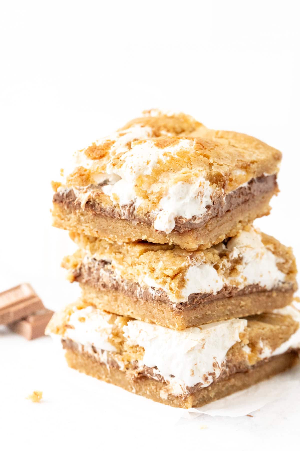 Stack of three s'mores cookie bars with chocolate and marshmallow cream in the middle