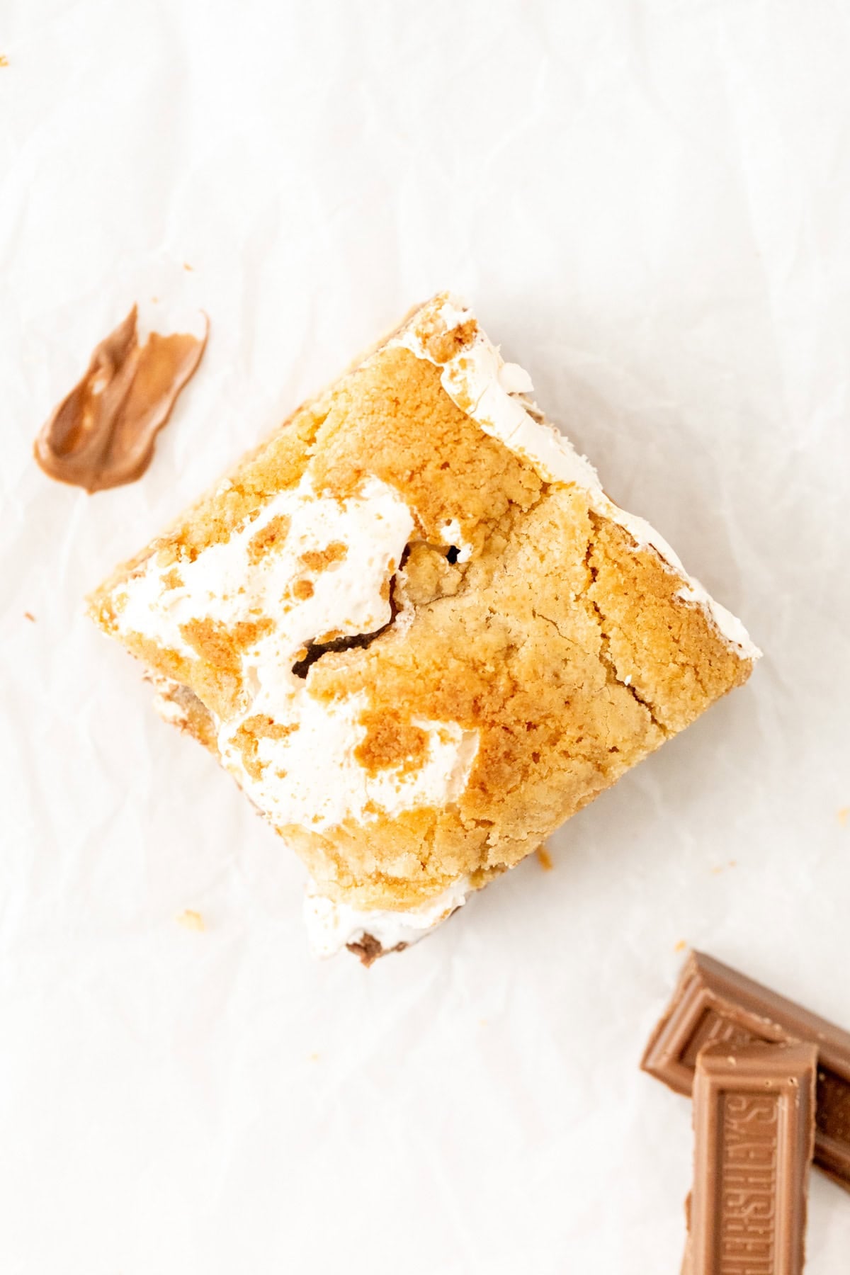 S'mores blondie cut into a square, with marshmallow fluff