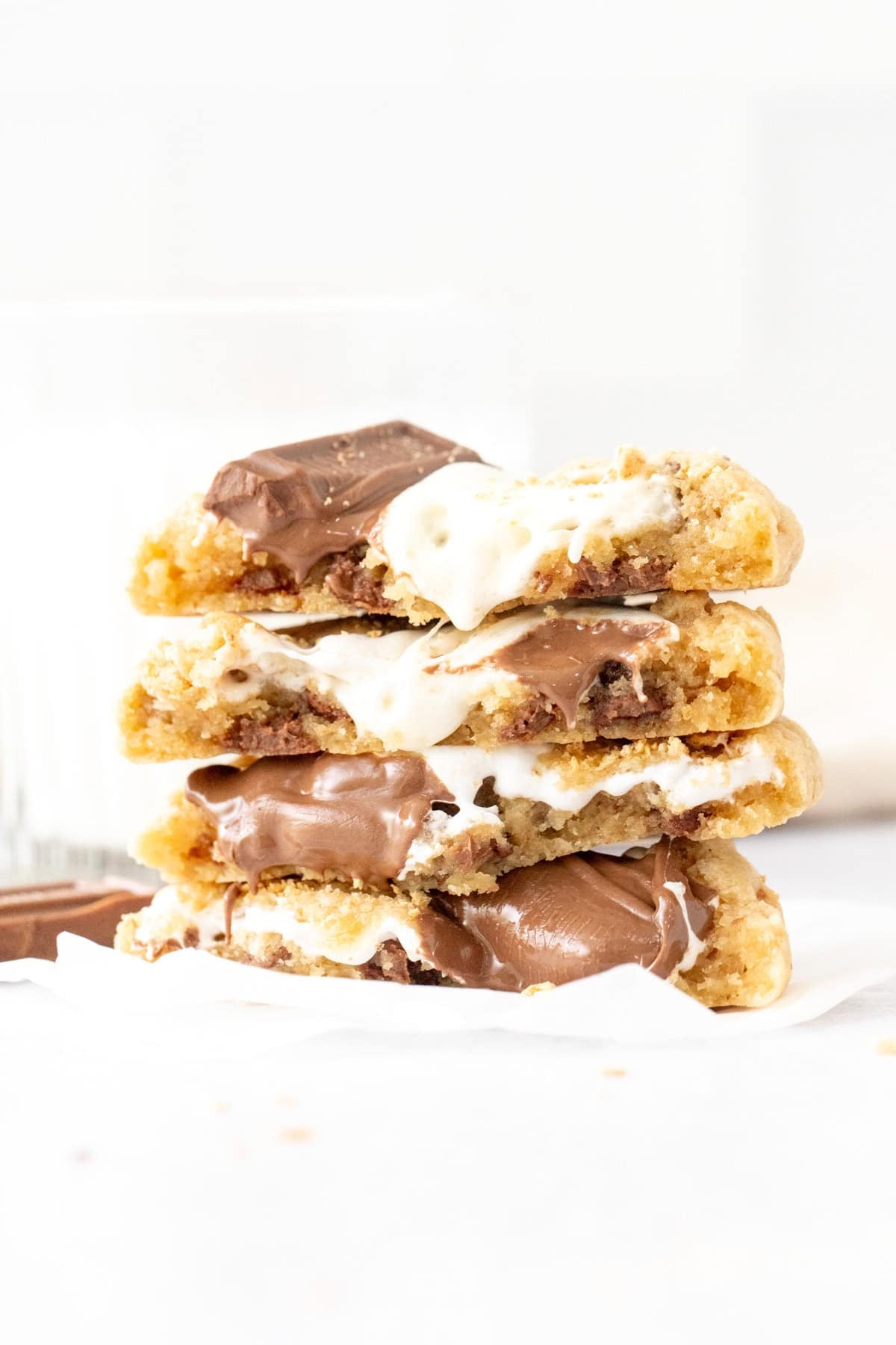 Stack of gooey s'mores cookies with marshmallow and melted milk chocolate, broken in half and stacked