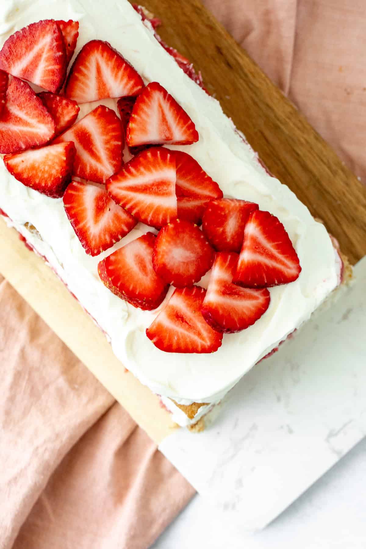 Strawberries and cream icebox cake topped with sliced berries