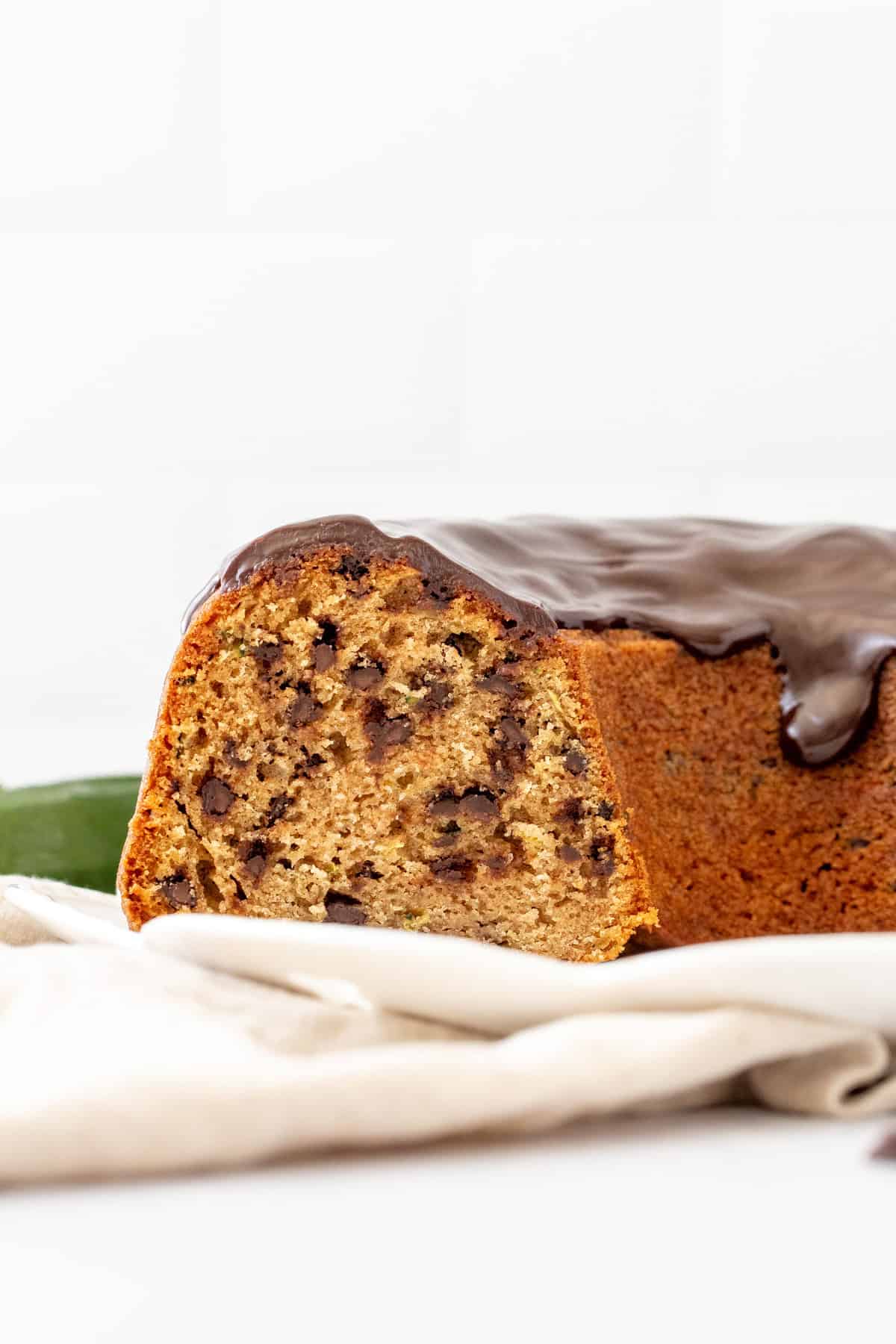 chocolate chip zucchini bundt cake with slices cut out of the cake
