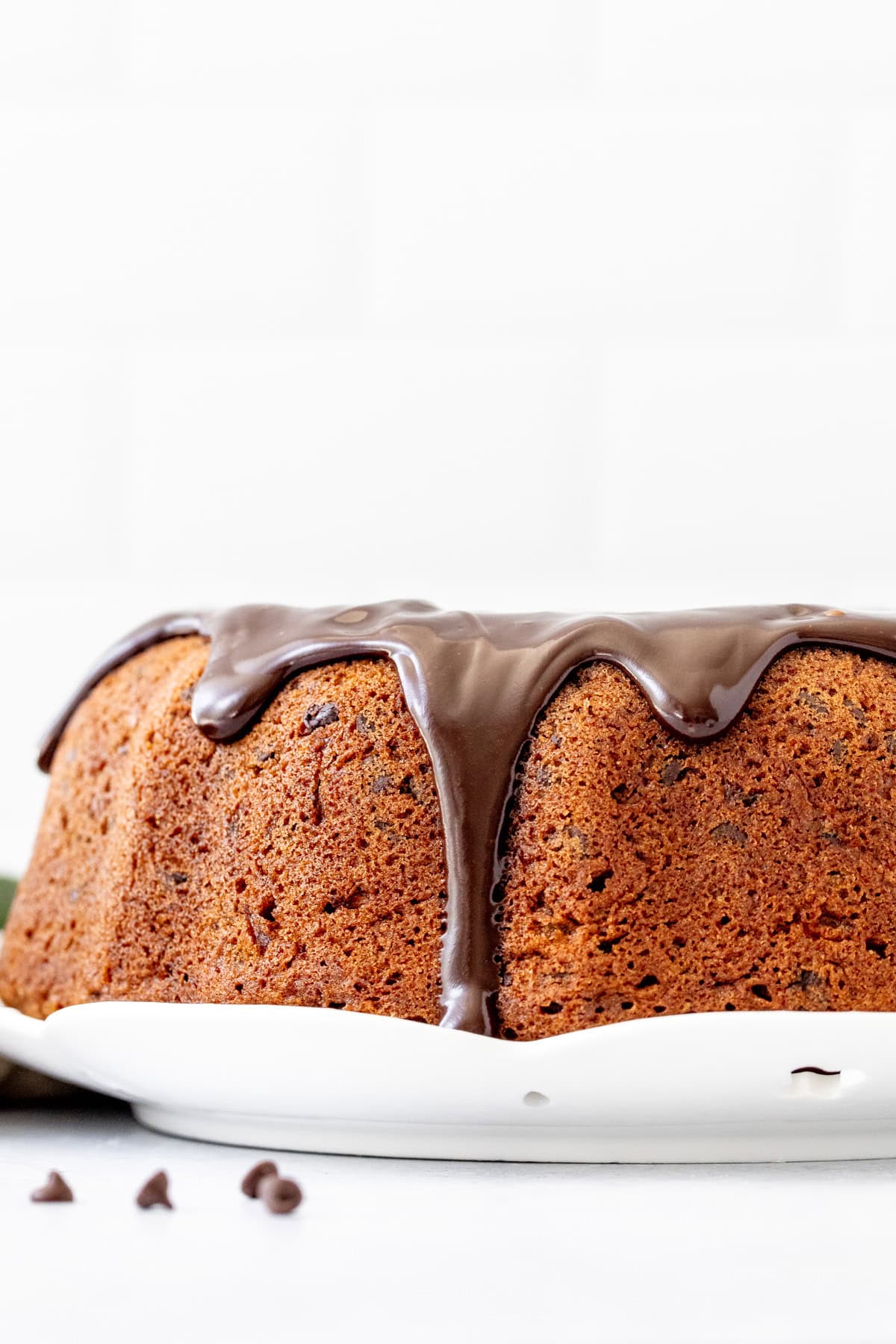 zucchini bundt cake with chocolate ganache drizzled over the top