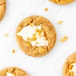 Fluffernutter cookies with marshmallow fluff in the middle and chopped peanuts on top