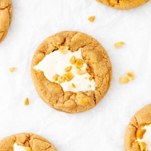 Fluffernutter cookies with marshmallow fluff in the middle and chopped peanuts on top