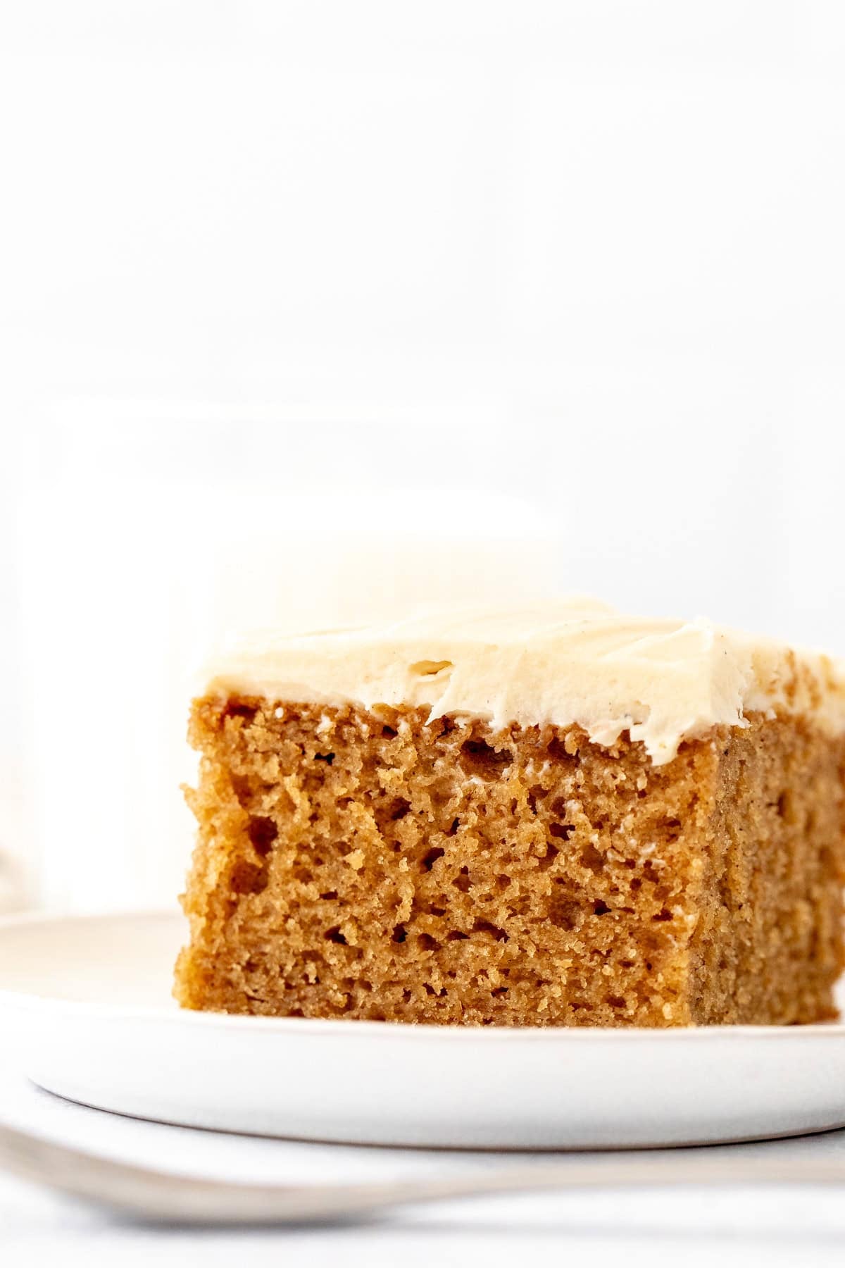 slice of spice cake with brown butter cream cheese frosting
