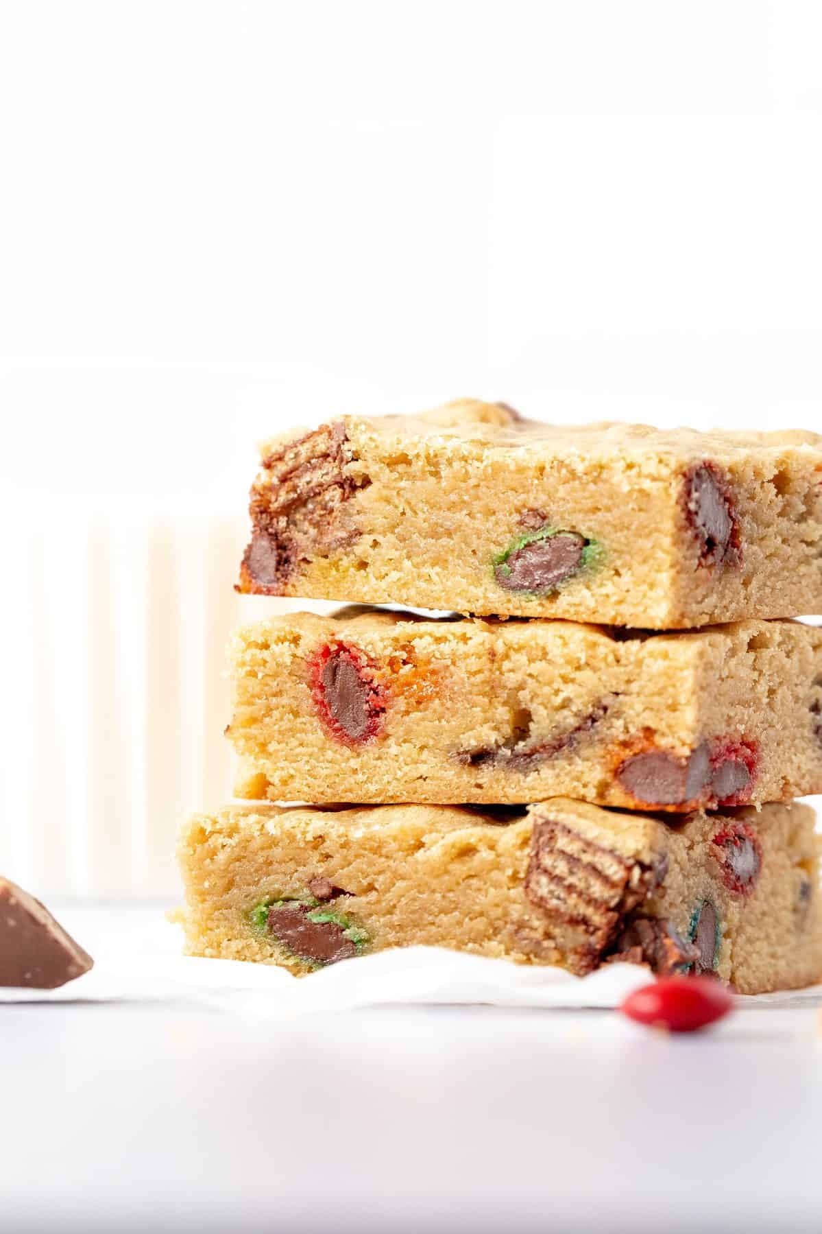 stack of 3 blondies made with M&Ms, KitKats and peanut butter cups