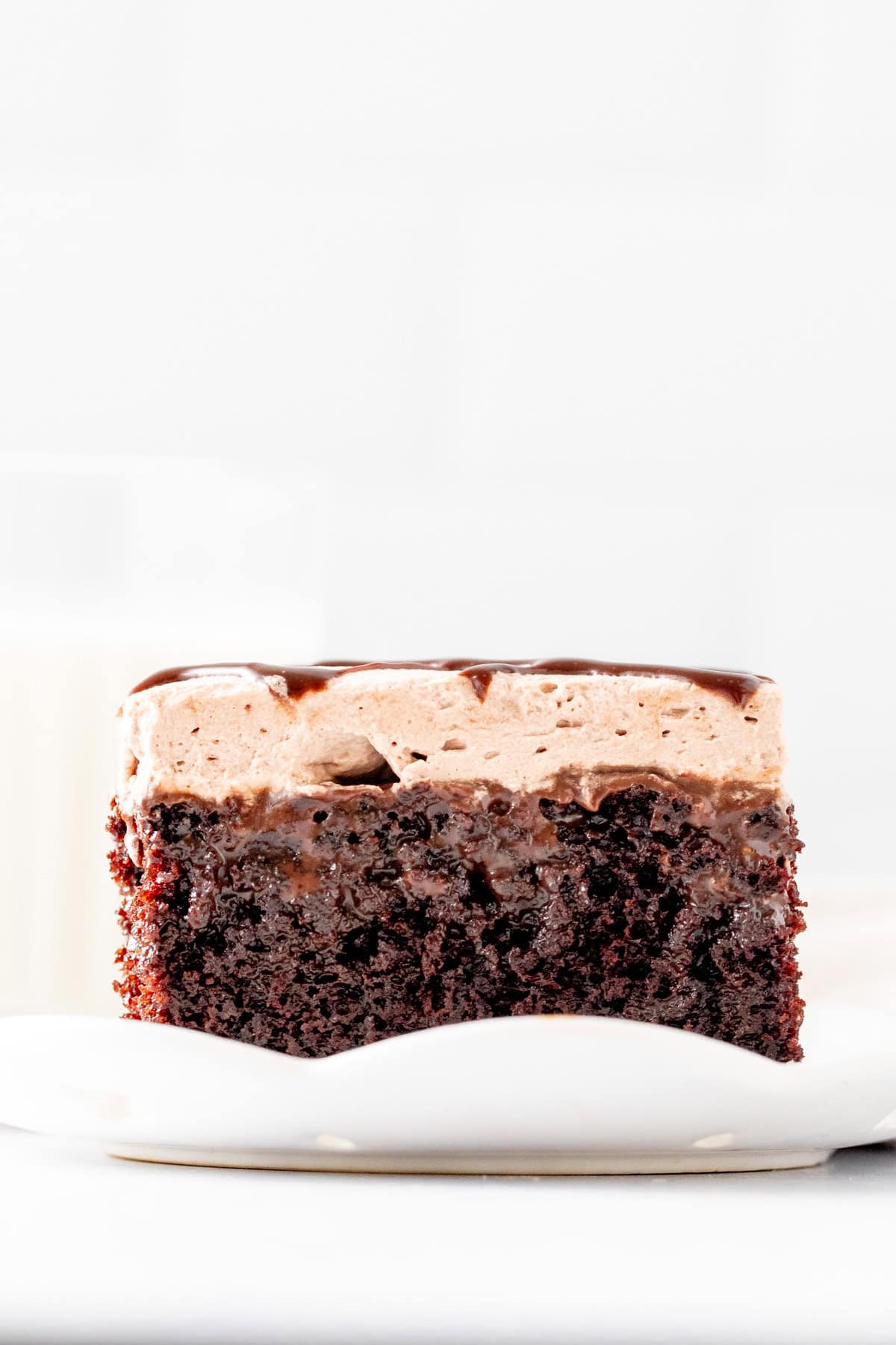 Slice of gooey chocolate poke cake