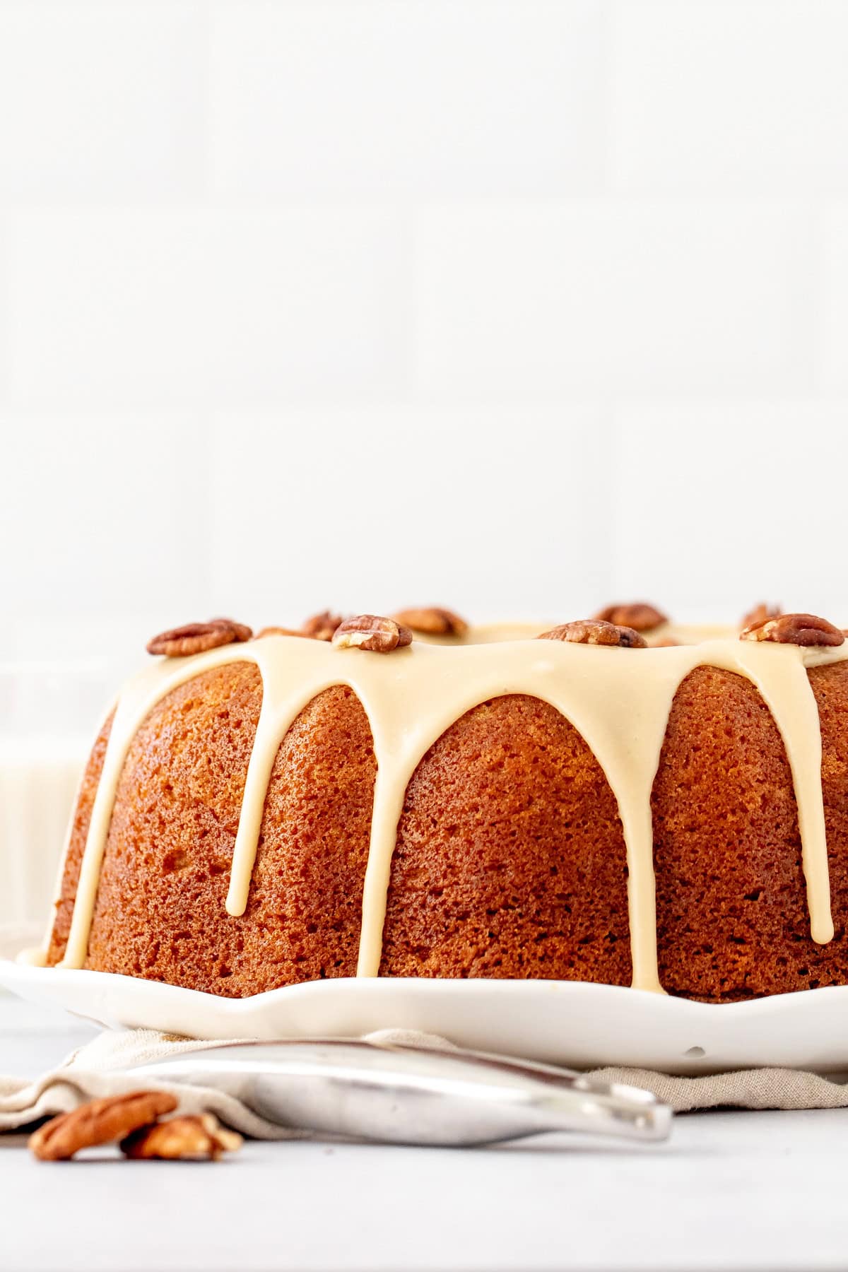 maple bundt cake with maple icing and pecans on top