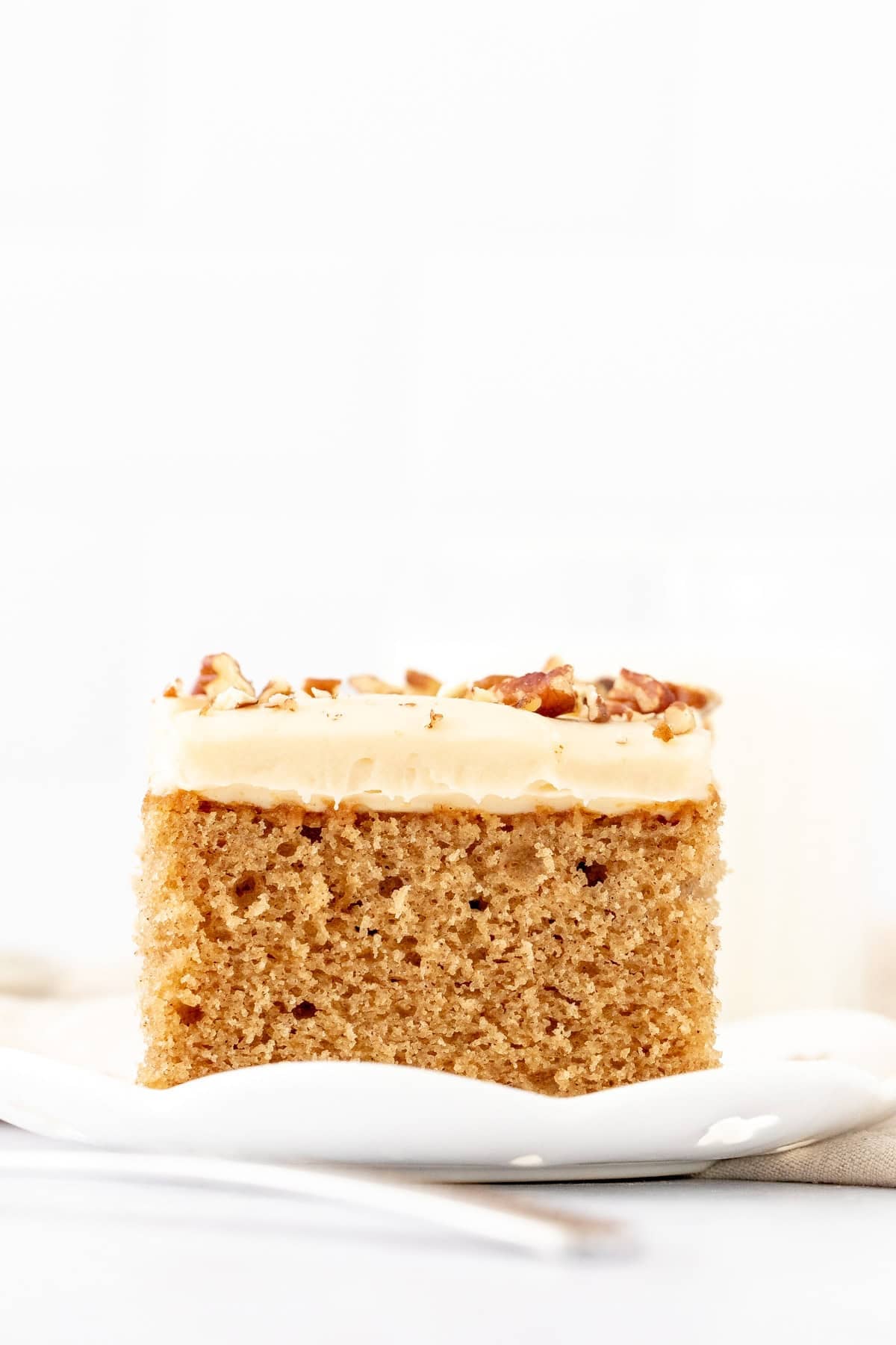 Slice of maple cake with maple cream cheese frosting